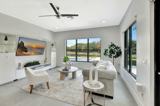 living area with a healthy amount of sunlight, ceiling fan, visible vents, and recessed lighting