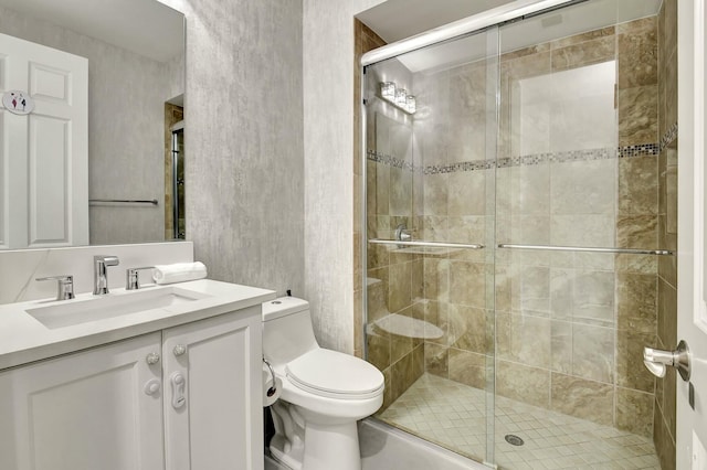 full bath featuring toilet, vanity, and a stall shower
