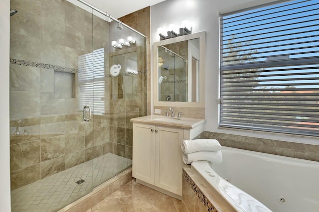 bathroom with a stall shower, a jetted tub, vanity, and tile patterned floors