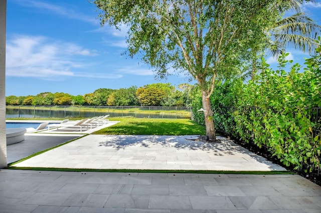 view of patio / terrace with a fenced backyard, a fenced in pool, and a water view