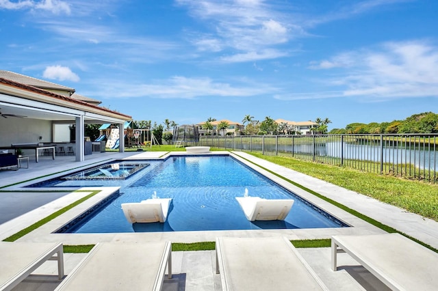 view of swimming pool with a patio, a fenced backyard, a water view, a pool with connected hot tub, and a playground