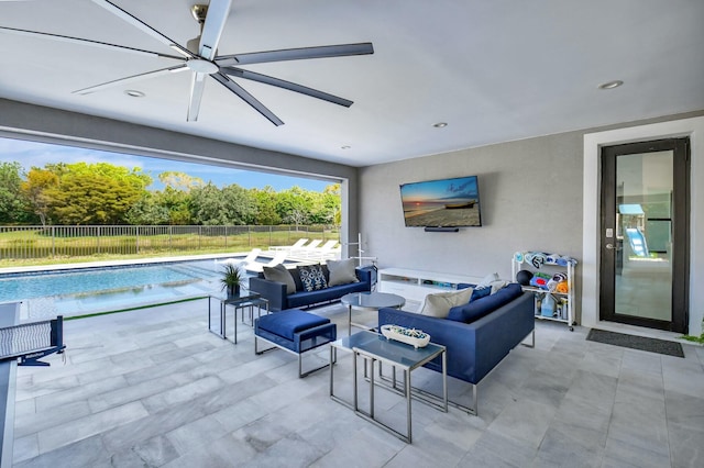 view of patio / terrace with outdoor lounge area, a fenced in pool, fence, and a ceiling fan