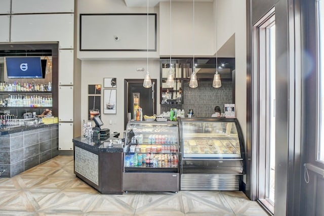 interior space featuring tasteful backsplash and a community bar