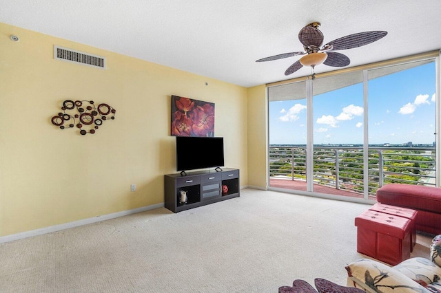1551 N Flagler Dr Unit 1509, West Palm Beach, FL 33401 - carpeted living area with visible vents, baseboards, a ceiling fan, and a wall of windows