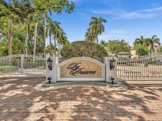 community / neighborhood sign featuring a gate