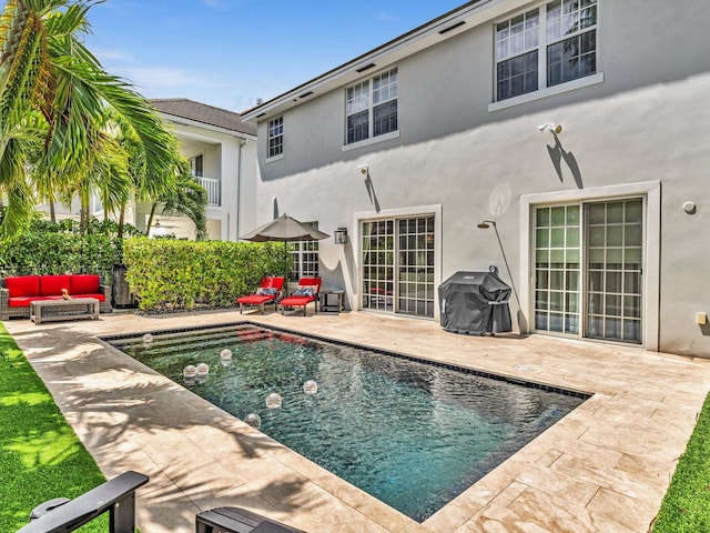 exterior space featuring a grill, a patio, and outdoor lounge area