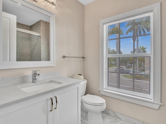 full bath with toilet, a shower stall, marble finish floor, and vanity