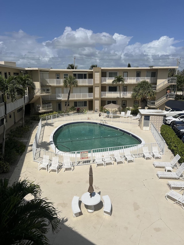 pool featuring a patio area and fence