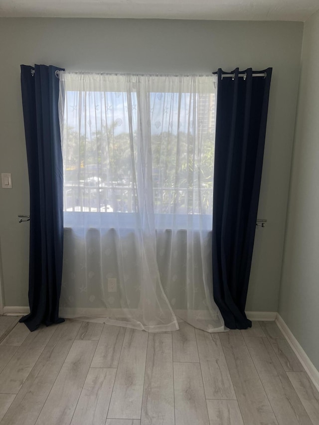 spare room with baseboards and wood tiled floor