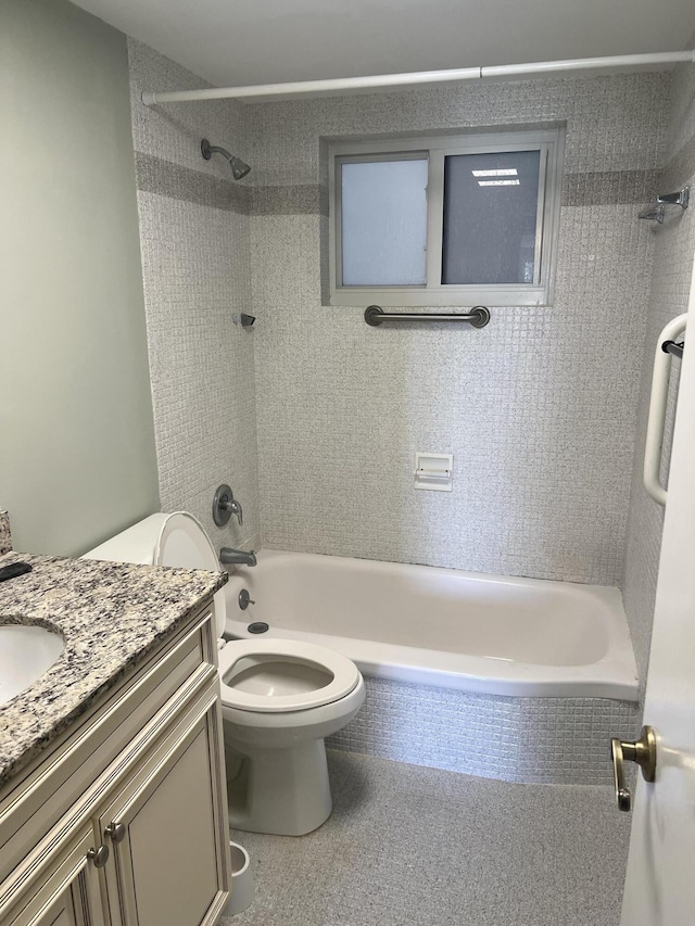 bathroom with washtub / shower combination, toilet, and vanity