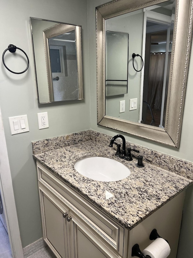 bathroom featuring baseboards and vanity