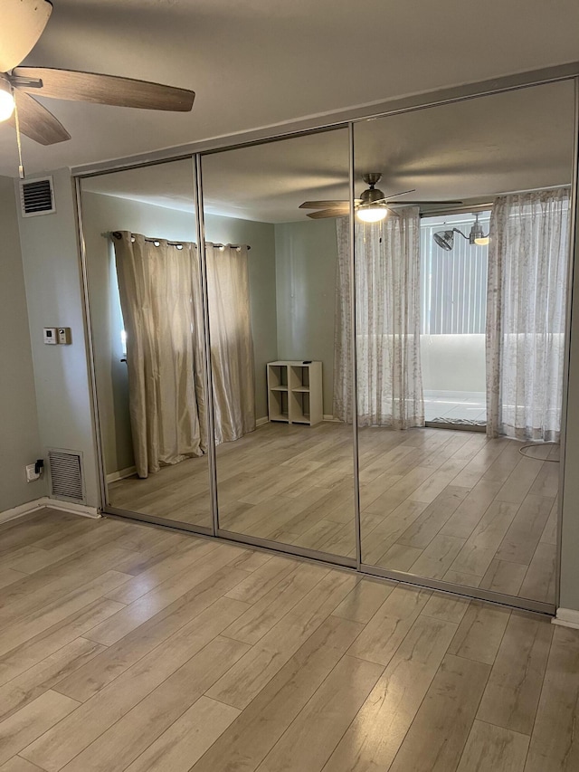 unfurnished bedroom with visible vents and wood finished floors