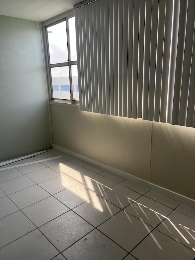 spare room featuring baseboards