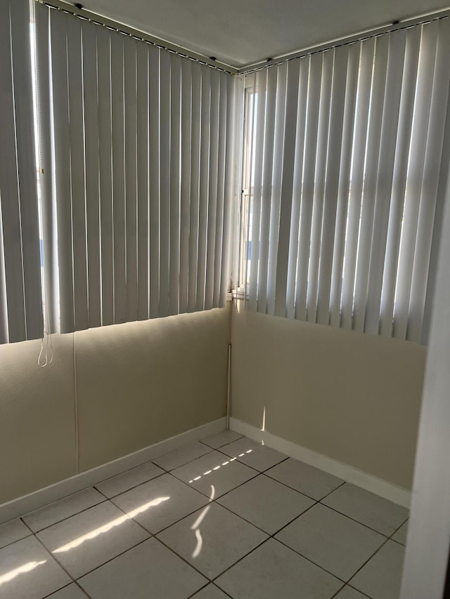 unfurnished room with tile patterned flooring