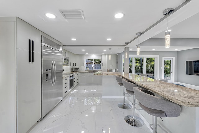 1900 NE 16th Ter, Fort Lauderdale, FL 33305 - kitchen featuring visible vents, modern cabinets, a sink, appliances with stainless steel finishes, and marble finish floor