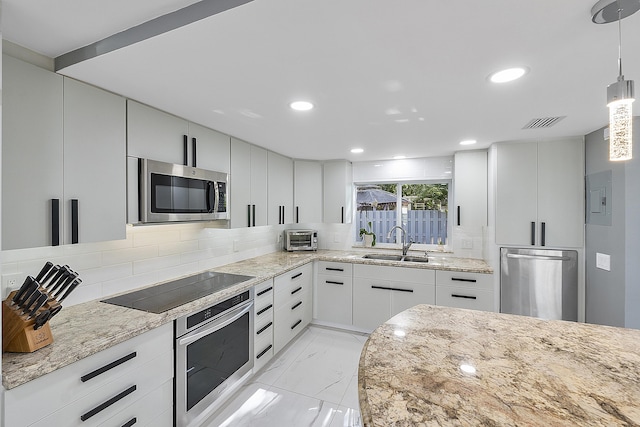 1900 NE 16th Ter, Fort Lauderdale, FL 33305 - kitchen featuring visible vents, light stone counters, marble finish floor, a sink, and stainless steel appliances