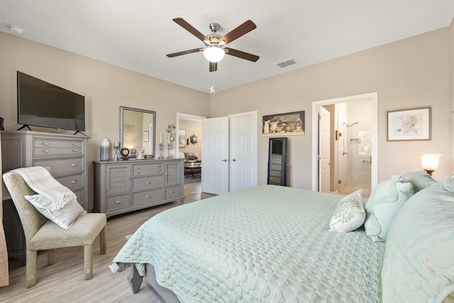 7753 SW 86th Loop, Ocala, FL 34476 - bedroom with light wood finished floors, a ceiling fan, and ensuite bath