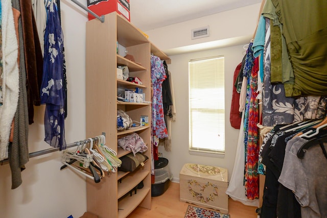 walk in closet featuring visible vents and wood finished floors