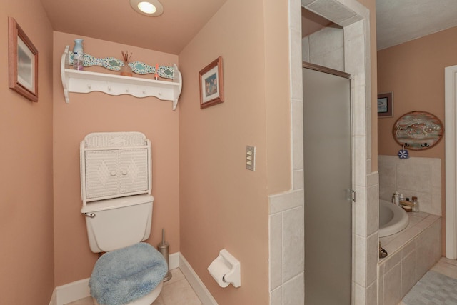 full bath with tile patterned flooring, toilet, baseboards, a shower stall, and a garden tub