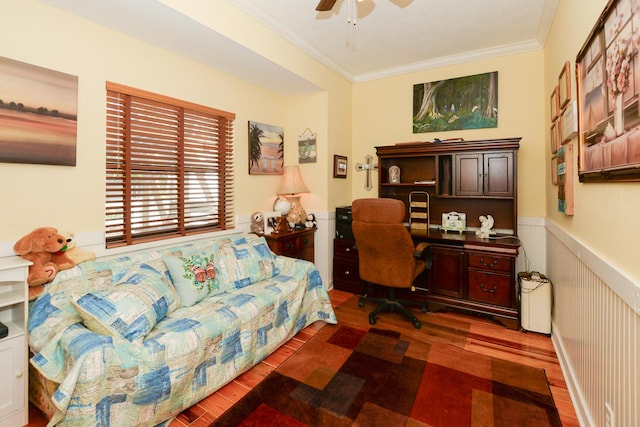 office space featuring crown molding, a ceiling fan, wainscoting, and wood finished floors