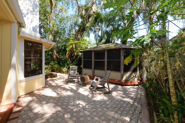view of patio / terrace featuring a sunroom