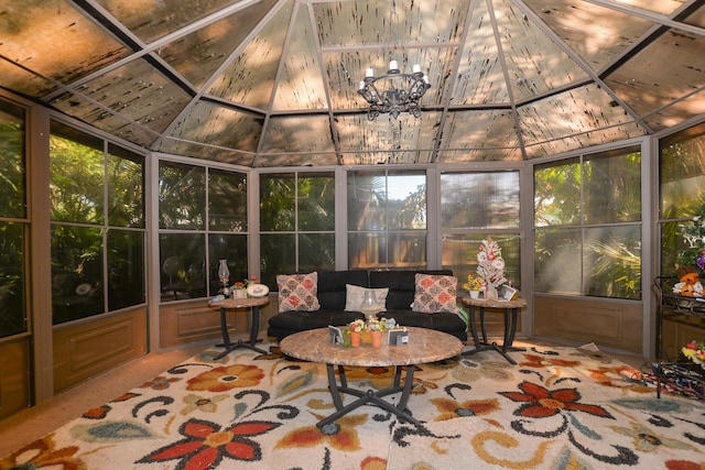 sunroom with an inviting chandelier and lofted ceiling