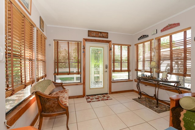 sunroom featuring crown molding, tile patterned floors, and baseboards