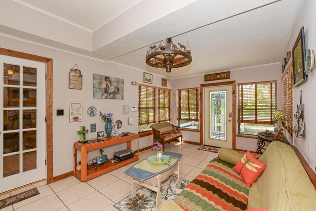 living area with baseboards, crown molding, and light tile patterned floors