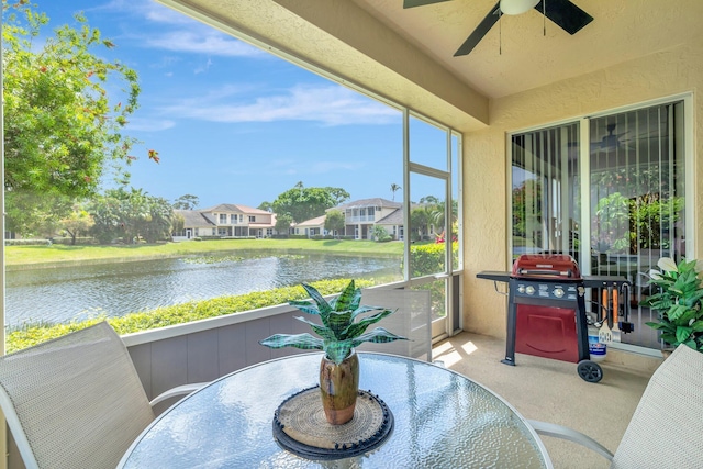 9225 Wentworth Ln, Port Saint Lucie, FL 34986 - sunroom / solarium with carpet flooring, a textured wall, a ceiling fan, and a water view