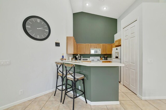 9225 Wentworth Ln, Port Saint Lucie, FL 34986 - kitchen with baseboards, white appliances, light tile patterned floors, light countertops, and high vaulted ceiling