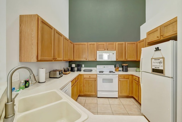 9225 Wentworth Ln, Port Saint Lucie, FL 34986 - kitchen featuring a towering ceiling, white appliances, light tile patterned floors, light countertops, and a sink