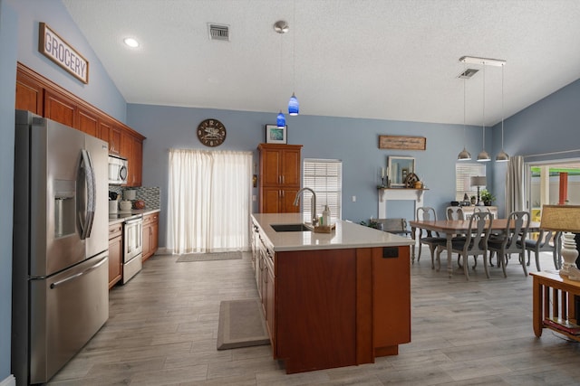1103 Aviary Rd, Wellington, FL 33414 - kitchen with stainless steel appliances, visible vents, a sink, and lofted ceiling