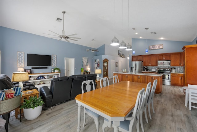 1103 Aviary Rd, Wellington, FL 33414 - dining room with visible vents, high vaulted ceiling, a ceiling fan, and light wood-type flooring