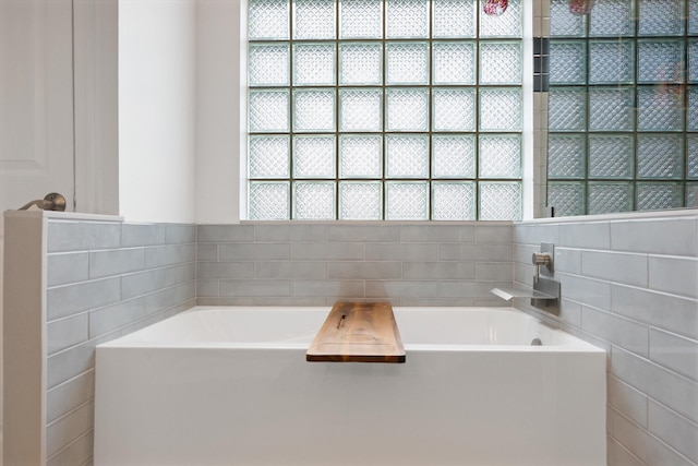 1103 Aviary Rd, Wellington, FL 33414 - bathroom featuring a bath and tile walls