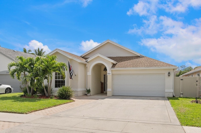 1103 Aviary Rd, Wellington, FL 33414 - view of front of property with concrete driveway, stucco siding, a gate, and an attached garage
