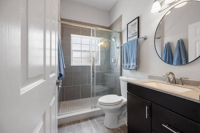 1103 Aviary Rd, Wellington, FL 33414 - full bath with vanity, a stall shower, toilet, and wood finished floors
