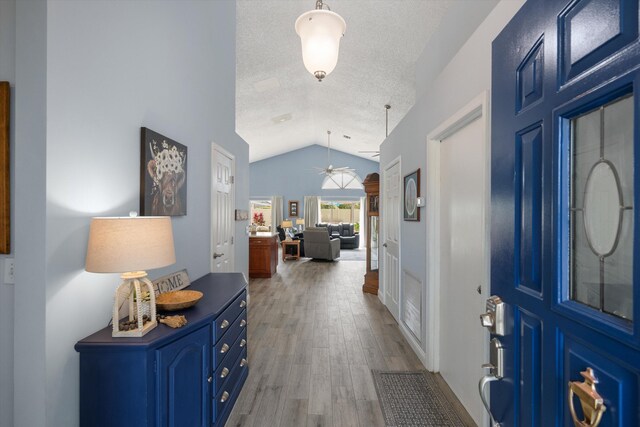 1103 Aviary Rd, Wellington, FL 33414 - foyer featuring a textured ceiling, wood finished floors, a ceiling fan, and vaulted ceiling