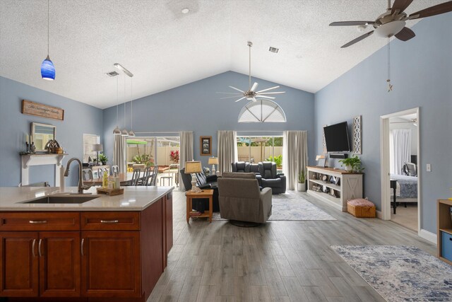 1103 Aviary Rd, Wellington, FL 33414 - kitchen featuring open floor plan, light countertops, ceiling fan, high vaulted ceiling, and a sink