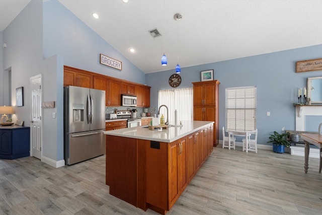 1103 Aviary Rd, Wellington, FL 33414 - kitchen featuring light wood-style flooring, visible vents, appliances with stainless steel finishes, light countertops, and a sink