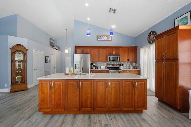 1103 Aviary Rd, Wellington, FL 33414 - kitchen featuring high vaulted ceiling, visible vents, light countertops, stainless steel appliances, and light wood finished floors
