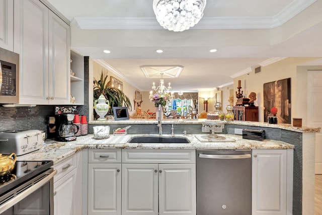 5749 Gemstone Ct Unit 107, Boynton Beach, FL 33437 - kitchen featuring stainless steel appliances, a sink, an inviting chandelier, and crown molding
