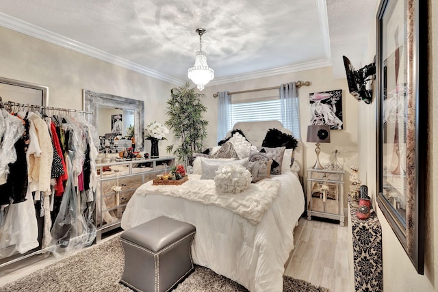 5749 Gemstone Ct Unit 107, Boynton Beach, FL 33437 - bedroom with light wood-style flooring, ornamental molding, and an inviting chandelier