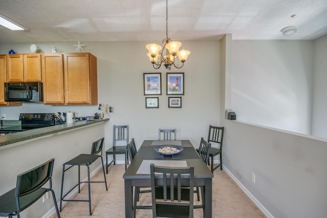dining room with baseboards, a chandelier, light carpet, and a textured ceiling