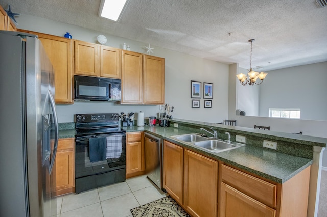 kitchen featuring a chandelier, a peninsula, light tile patterned floors, black appliances, and a sink