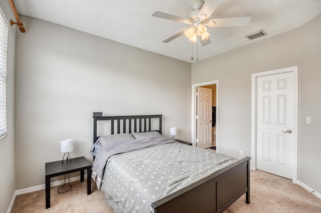 bedroom featuring ceiling fan, light colored carpet, baseboards, and visible vents