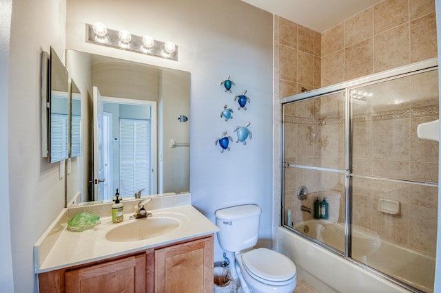 full bathroom with toilet, vanity, and enclosed tub / shower combo