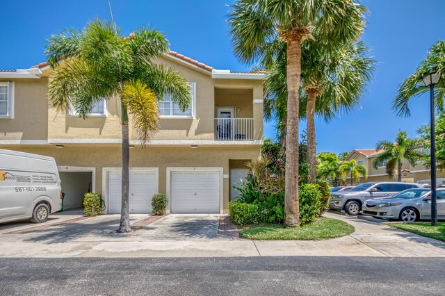 112 Lighthouse Cir Unit J, Tequesta, FL 33469 - townhome / multi-family property featuring stucco siding, an attached garage, and a tile roof