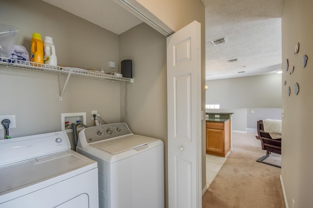 laundry area featuring visible vents, baseboards, laundry area, independent washer and dryer, and light colored carpet
