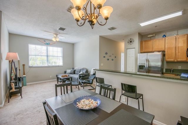 dining space featuring visible vents, baseboards, and a textured ceiling