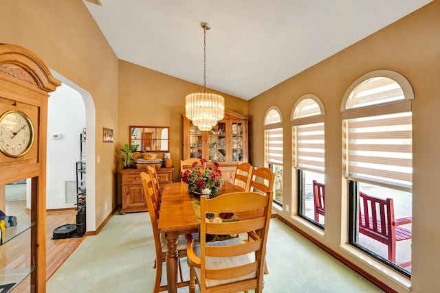 3120 SE Downwinds Rd, Jupiter, FL 33478 - dining space with an inviting chandelier, arched walkways, light carpet, and plenty of natural light